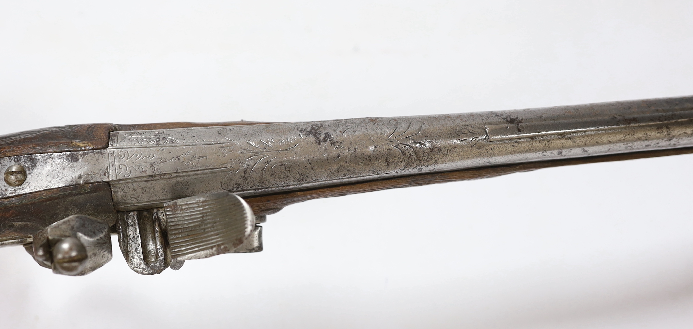 A Turkish Flintlock holster pistol with brass mounts, long spur butt cap, engraved lock and carved stock, barrel 29.5cm